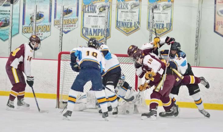 Sparta-Jefferson United goalie Logan Hanek drops down and blocks the puck during a Madison shot in the first period.