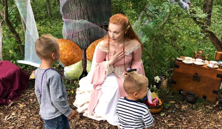 A fairy talks to children at the Renaissance Festival.