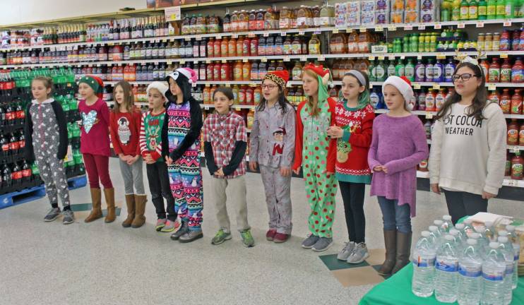 Girl Scouts bring cheer to Shoprite by singing carols. (Photos provided).