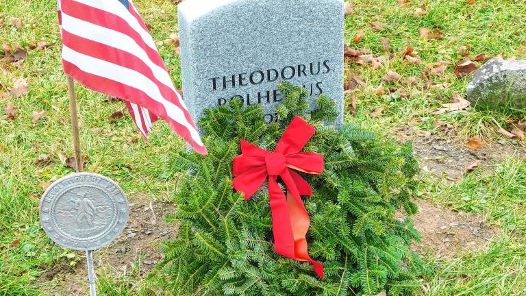 <b>The gravestone of Revolutionary War veteran Theodorus Polhemus in the Old Newton Cemetery is decorated as part of Wreaths Across America in December 2018. The gravestone was erected in October 2018 as part of a joint effort of the Daughters of the American Revolution, Sussex County Historical Society and Old Newton Cemetery Committee to locate and mark previously unmarked graves. Polhemus was born in Haverstraw, N.Y., and served as a corporal in the Orange County, N.Y., militia. He died in Newton in 1820. (Photo by Mandy Coriston)</b>