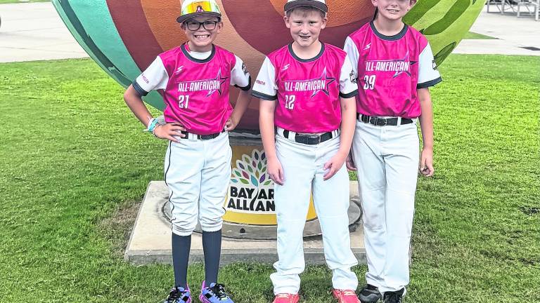 Liam McQueeny, Michael Egger and Jaxon Hiler pose for a photo.