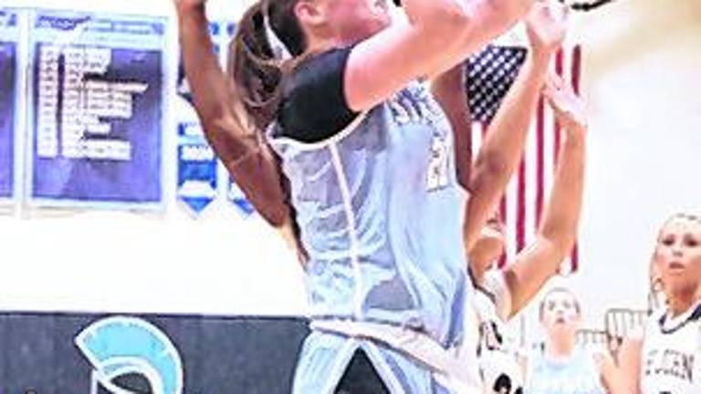 Sparta's Brooke Shust (21) leaps towards the hoop during a shot.