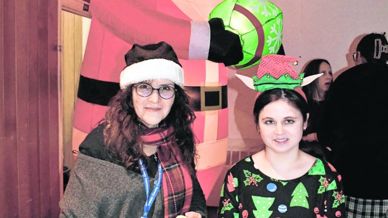 <b>Michelle Tagliabue and Katie Healy of Wantage stand in front of a Santa inflatable.</b>
