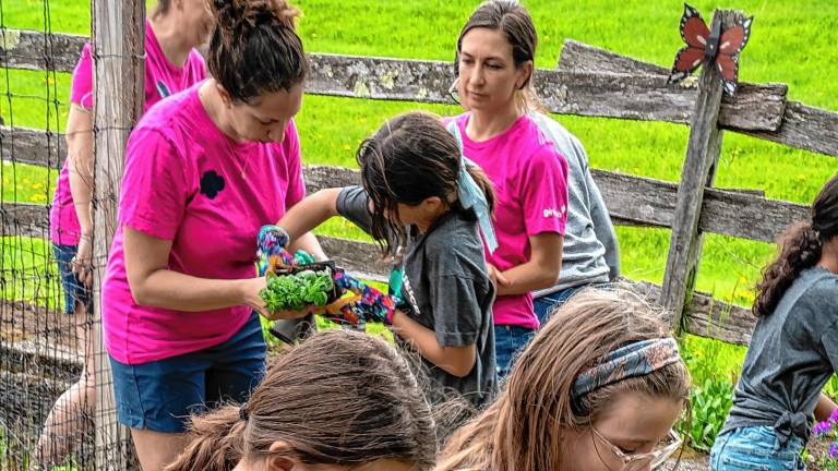 Girl Scouts Brianna Davis and Amelia Towe plant flowers in the community garden during the Earth Day Fair on Saturday, May 3 at Sparta Middle School. (Photos by Nancy Madacsi)