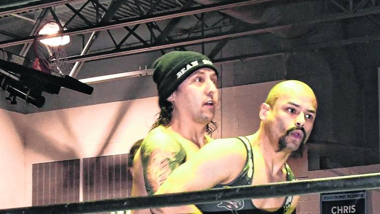 Two wrestlers perform.