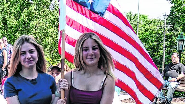 Brenna Koroski and Juliana paoluzzi carry the first official flag of the U.S.