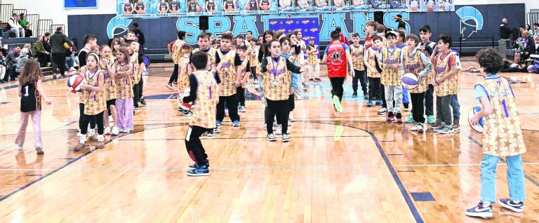 Kids participate in a game with the Harlem Wizards.