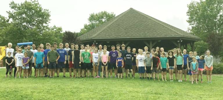 O'Sullivan poses with campers at this year's X-Treme Youth Running Camp. He is right in the center behind the girl in white and the girl in pink.