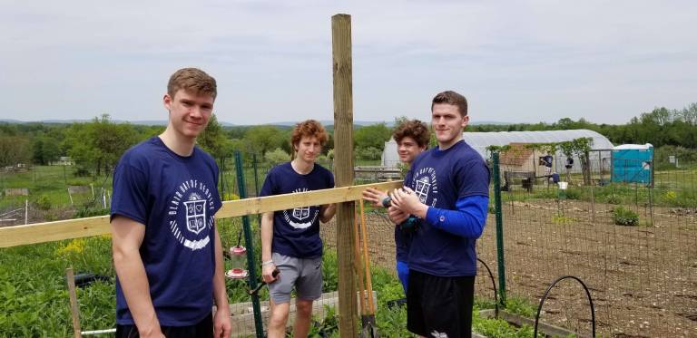 Tucker Richardson, Henry Meyers, Nick Incontrera and Jack Six of Blair Academy volunteer their services at Sunset View Farm's new Children's Educational Garden.