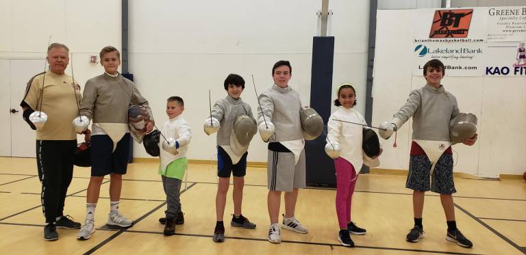 From left: National Fencing Alliance (NFA) Maestro Trudnos,,Allen Trudnos ( Pope John High School), Raymond Galinski ( Pope John Middle School), Griffin Brawer (Sparta middle School), Kaden Kambak (Sparta High School) , Benjamin Giralt (Sparta Middle School), Mila Valentin ( Pope John Middle School).