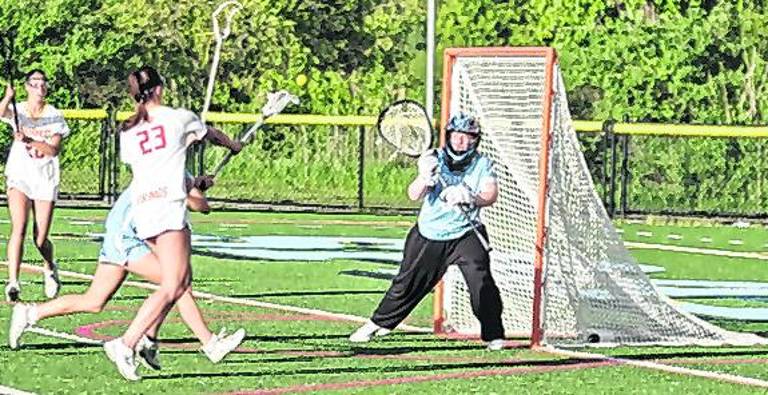 Voorhees' Elizabeth Rojewski (23) uses her crosse to launch the ball towards the goal post as Sparta's goalie Callie Maines stands guard, Maines made 11 saves.