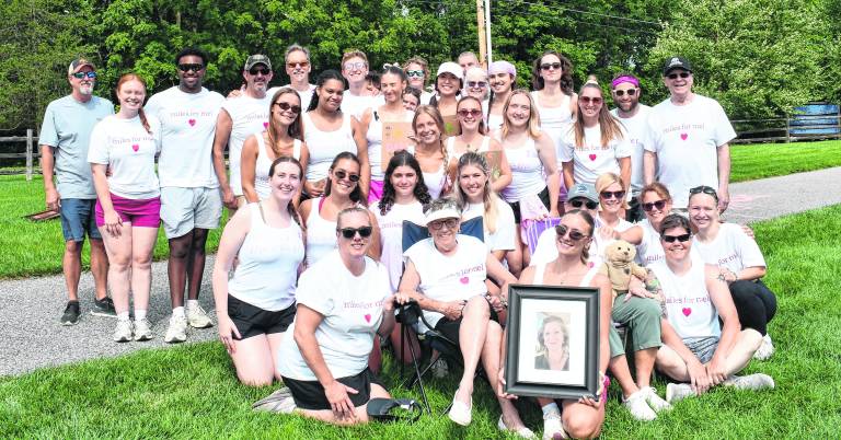Maddie Sacchiero holds a photo of her mother, Mel Sacchiero.
