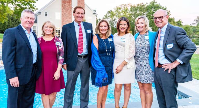Enjoying the Tri-County 2016 Dinner Committee kick-off meeting, poolside at the home of Tammy and Joseph Spada in Mendham, are (left to right) Tri-County trustees, Ken Donovan, president of Fiddler's Elbow Country Club, and Kris Donovan of Mendham, Terry and Prudence Pigott of Far Hills, Tri-County Scholarship graduate and guest speaker Janiela Campusano, originally of Paterson and now a Chubb employee in New York City, and Susanne Waldele and her husband Robert Waldele, managing director of Merrill Lynch, of Stirling.