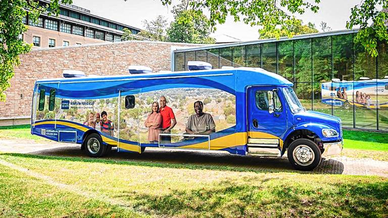 The 40-foot mobile medical unit’s passenger side reflects three key populations served by the vehicle: children, older adults and veterans.