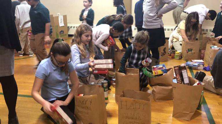 Hilltop Country Day School students follow their school's compassionate tradition of collecting donations for the Sparta Food Pantry. Left to right, Evelyn Cotter, grade 6; Allison Bliss, grade 6; Abby Iussig, grade 1. (Photo provided).