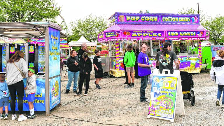 <b>Visitors walk the midway at the Memorial Day Carnival at Skylands Stadium.</b>