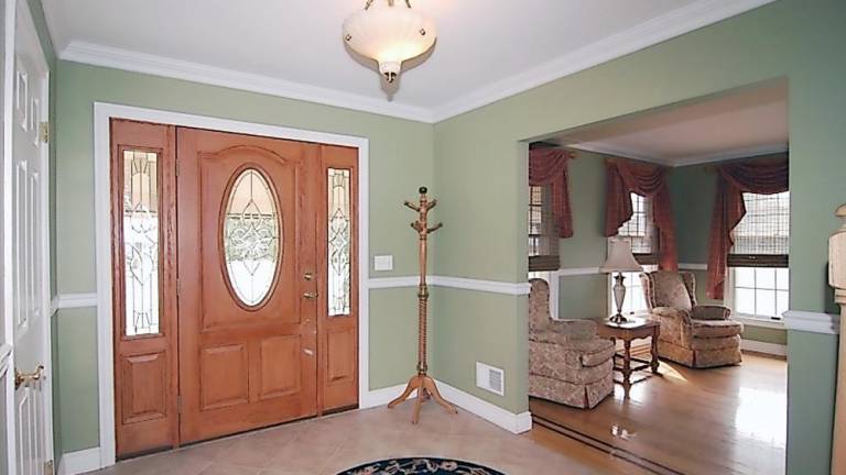 Spacious center hall colonial has in-ground pool