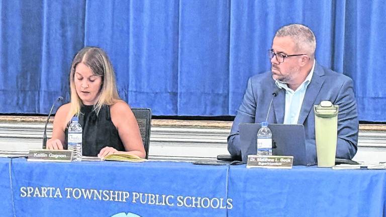 Sparta Public Schools Board of Education President Kaitlin Gagnon, left, speaks as Superintendent Matthew Beck looks on.