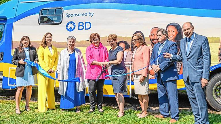 Executives from Zufall Health and lead sponsor BD cut a ribbon on the new mobile medical unit. From left are Ami Simunovich, BD chief quality &amp; regulatory officer and public affairs; Carla Burigatto, BD chief communications officer; Peg Zufall, a Zufall board member; Shana Neal, BD chief people officer; Fran Palm, Zufall president and chief executive; Annette Gonazlez, Zufall chief operating officer; David Woods, Zufall senior vice president of external affairs; and Peter Wolfson, Zufall Health Foundation board president. (Photos by April Ludwig)