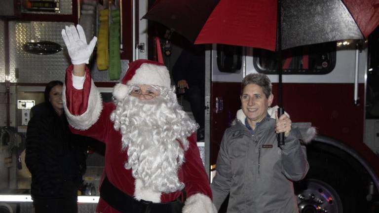 Santa arrives for Sparta’s annual Christmas tree lighting Dec. 1 at Town Hall. At right is Jeanne Montemarano, the township’s recreation director.