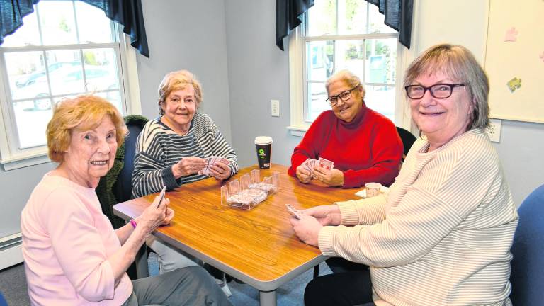 Joan Wills, Linda Fiedler, Gloria Diabo and Pat Kibildis, all of Sparta, play a card game.