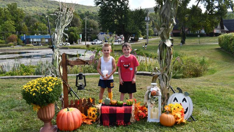 <b>Dougie Morrica and Conner Minter of Vernon pose in front of a fall display at the Vernon Street Fair on Saturday, Sept. 13. (Photo by Maria Kovic)</b>