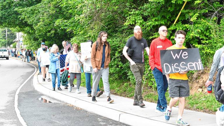 Residents march through Newton after a ‘No Kings’ protest Saturday, June 14 at the Newton Green. (Photos by Maria Kovic)