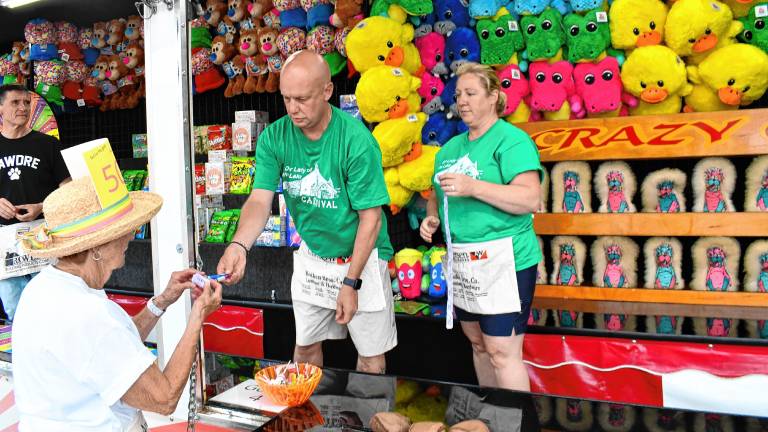 Steve and Amy Marshall of Sparta operate a game at the annual Our Lady of the Lake carnival in Sparta. (Photos by Maria Kovic)