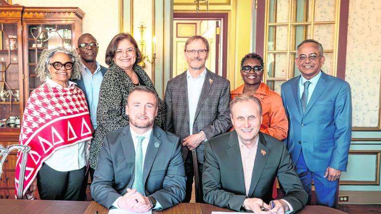 Standing, Dr. Wartyna Davis, WPU Dean of the College of Arts, Humanities and Social Sciences; Dr. Anthony Bowrin, WPU Dean of the Cotsakos College of Business; Nancy Gallo, SCCC Associate Vice-President of Academic Affairs; Dr. Josh Powers, WPU Provost; Dr. Djanna Hill, WPU Associate Dean of the College of Arts, Humanities and Social Sciences; and Dr. Venkat Sharma, WPU Dean of the College of Science and Health; seated: Dr. Cory Homer, SCCC President, and Dr. Richard Helldobler, WPU President.