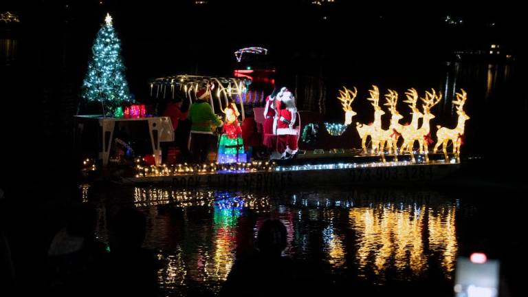 LM1 Santa and Mrs. Claus, an elf and reindeer ride on a barge on Lake Mohawk on Sunday, Dec. 3. The barge was designed by Caruso Lakeshore Construction &amp; Services. (Photos by Nancy Madacsi)