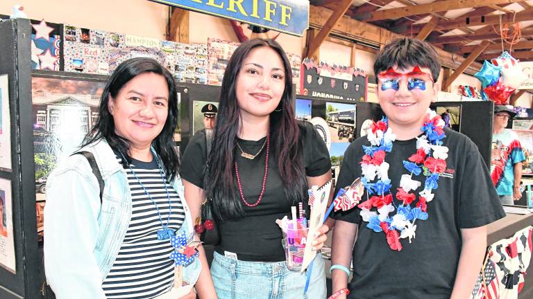 <b>Maria, Brislin and Alexander Lagunes of Sussex pose for a photo.</b>
