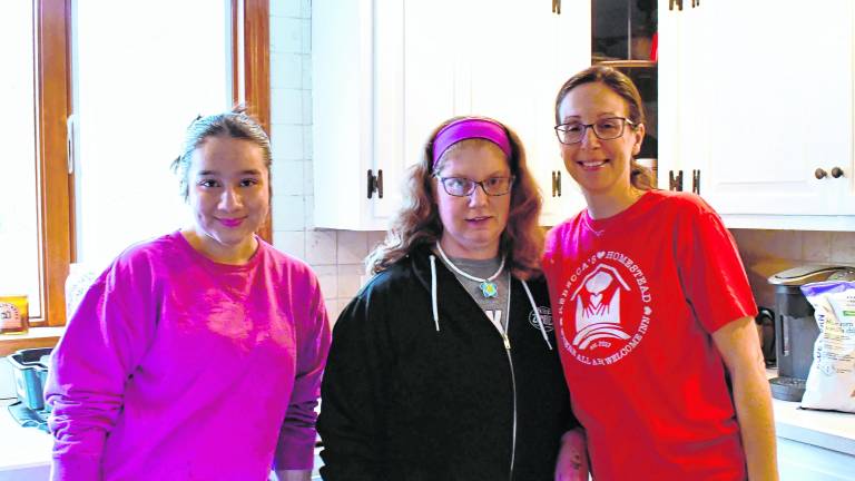 <b>Leeza Kaur of Pass It Along, Rebecca of Rebecca's Homestead and Theresa Senfelice cook for the volunteers.</b>