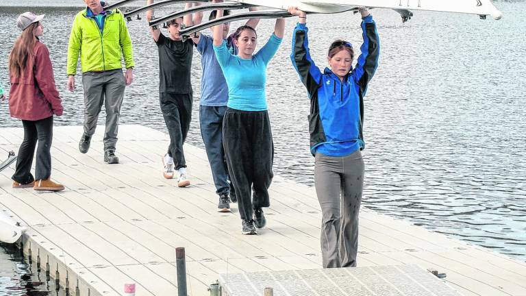 Members of the Sussex County Rowing Club carry a boat away from the water after a recent practice. The club is made up of Students from Sparta High School and Pope John XXIII Regional High School.