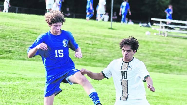 Kittatinny's Nathan Itnyre (15) and Sussex Tech's Cayle Marino (10) battle for control of the ball.