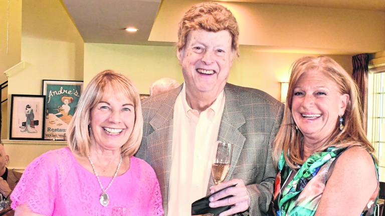Nancy porter is shown with Randy Burke, owner of Burke’s Liquor Store, and Marjy Murphy, public relations person for Sparta Food Pantry.