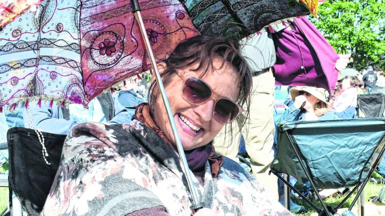 <b>Rebecca Pitras of Montague shades herself with an umbrella.</b>