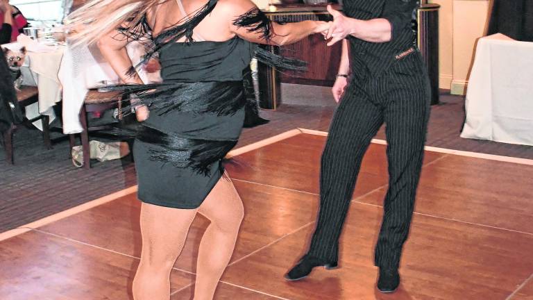 Award-winning dance instructors Olena Shvets Nikishkin and Dmitry Nikishkin dance.