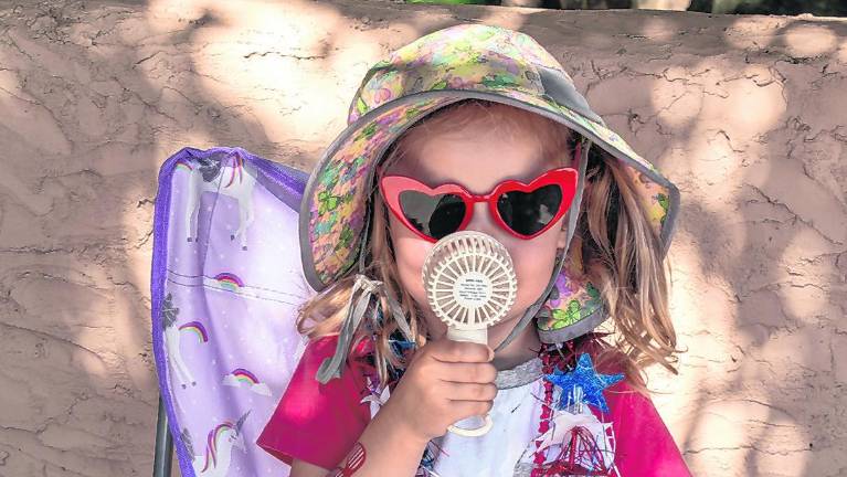Clara Bohm cools herself off during the parade.