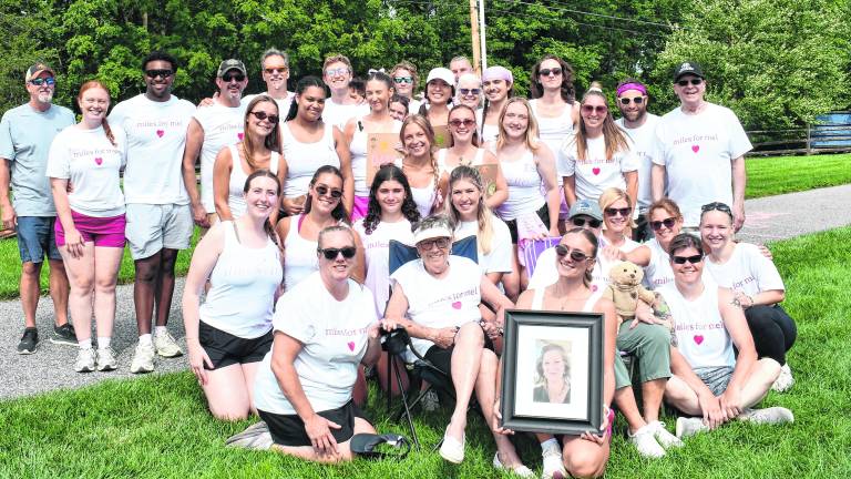 Maddie Sacchiero holds a photo of her mother, Mel Sacchiero.