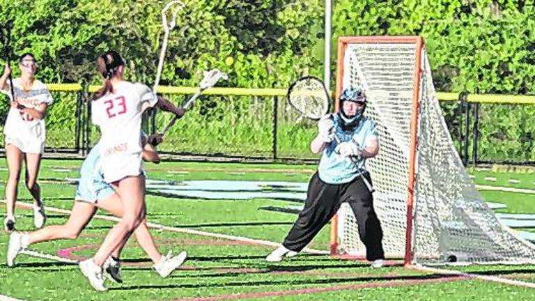Voorhees' Elizabeth Rojewski (23) uses her crosse to launch the ball towards the goal post as Sparta's goalie Callie Maines stands guard, Maines made 11 saves.