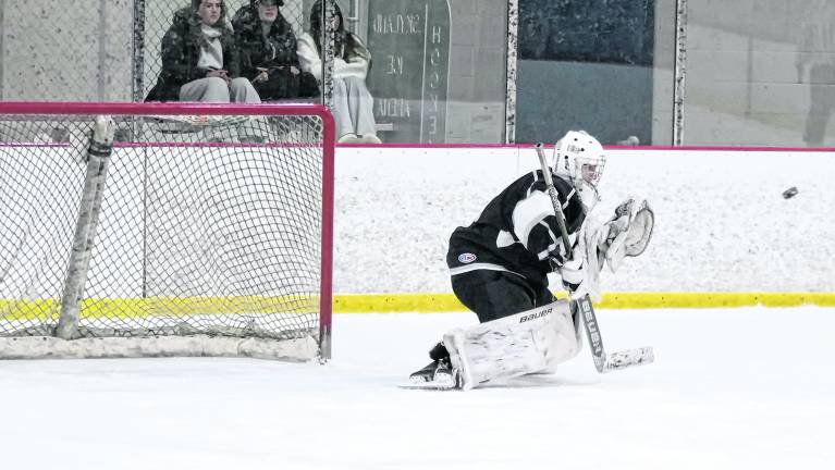 K.J.S. United's goalie Stefan Filewicz drops down to intercept the incoming puck. Filewicz made 27 saves.